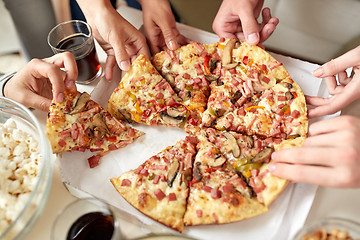 Image showing close up of people taking pizza slices from box