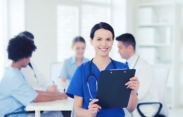 Image showing happy doctor over group of medics at hospital