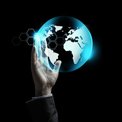 Image showing close up of businessman hand with earth projection