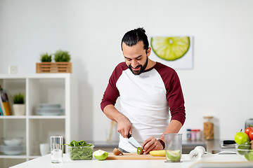 Image showing man with blender and fruit cooking at home kitchen