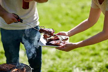 Image showing man cooking meat at summer party barbecue