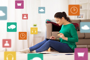 Image showing woman with tablet pc and credit card at home