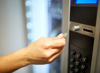 Image showing hand inserting euro coin to vending machine