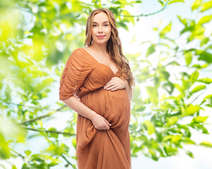 Image showing happy pregnant woman over summer green background