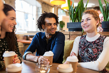 Image showing happy friends drinking coffee at restaurant