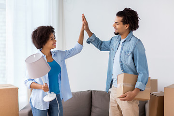 Image showing happy couple with stuff moving to new home