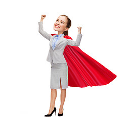 Image showing young smiling businesswoman in red superhero cape