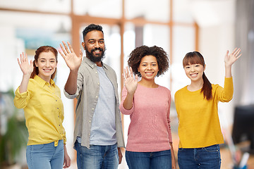 Image showing international group of happy people waving hands