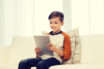 Image showing smiling boy with tablet computer at home