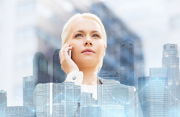 Image showing serious businesswoman with smartphone in city