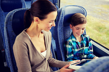 Image showing happy family with tablet pc sitting in travel bus