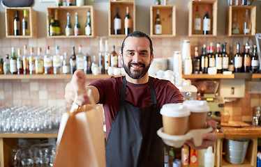 Image showing man or waiter with coffee and paper bag at bar