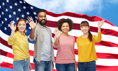 Image showing international group of happy people waving hands