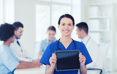 Image showing happy doctor over group of medics at hospital