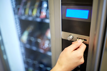 Image showing hand inserting euro coin to vending machine slot