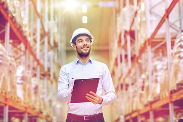 Image showing happy businessman with clipboard at warehouse