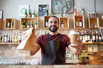 Image showing man or waiter with coffee and paper bag at bar