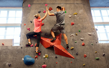 Image showing man and woman exercising at indoor climbing gym