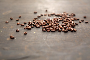 Image showing Coffee beans scattered on a black board