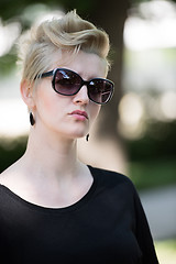 Image showing young woman with short blond hair and sunglasses