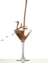 Image showing macro shoot with hot chocolate falling in glass on white in studio