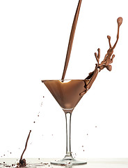 Image showing macro shoot with hot chocolate falling in glass on white in studio