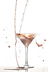 Image showing macro shoot with hot chocolate falling in glass on white in studio