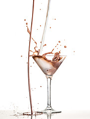 Image showing macro shoot with hot chocolate falling in glass on white in studio