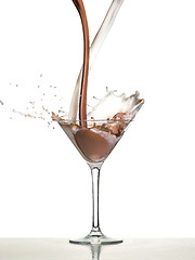 Image showing macro shoot with hot chocolate falling in glass on white in studio