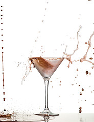 Image showing macro shoot with hot chocolate falling in glass on white in studio