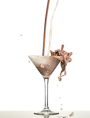 Image showing macro shoot with hot chocolate falling in glass on white in studio