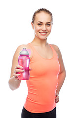 Image showing happy sportive young woman with water bottle