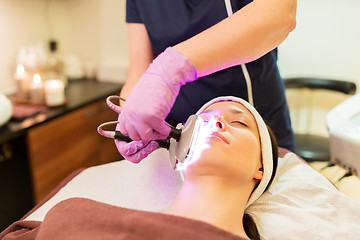 Image showing young woman having face microdermabrasion at spa