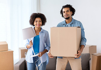 Image showing happy couple with stuff moving to new home