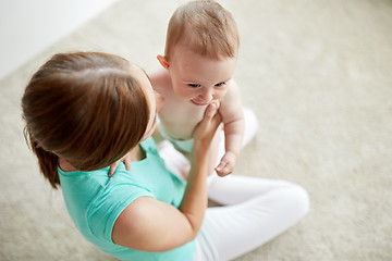 Image showing happy young mother with little baby at home