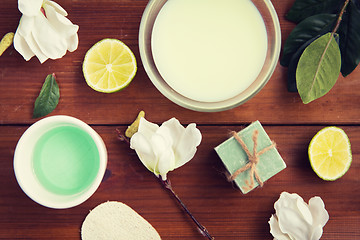 Image showing close up of body lotion, cream and soap on wood