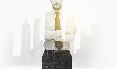 Image showing businessman with crossed arms over city buildings