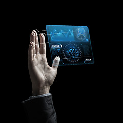 Image showing businessman hand with virtual charts over black