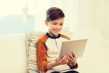 Image showing smiling boy with tablet computer at home