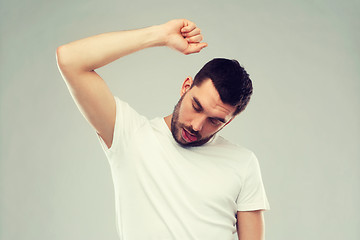 Image showing young making gallows gesture over gray background