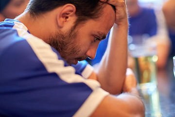 Image showing close up of sad football fan at bar or pub