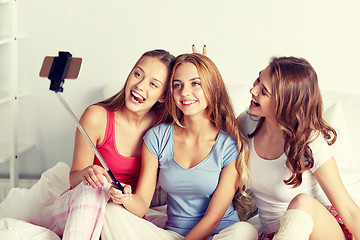 Image showing teen girls with smartphone taking selfie at home