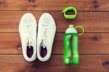 Image showing close up of sneakers, bracelet and water bottle