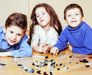 Image showing funny cute children playing toys at home, boys and girl smiling, first education role lifestyle 