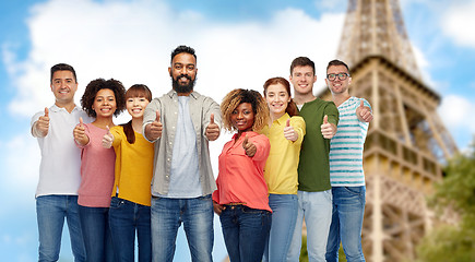 Image showing  people showing thumbs up over eiffel tower