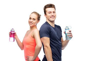 Image showing sportive man and woman with water bottles
