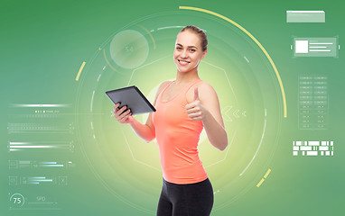 Image showing happy smiling sportive young woman with tablet pc