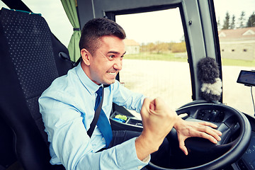 Image showing angry driver showing fist and driving bus