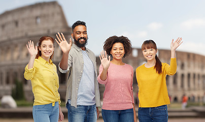 Image showing international group of happy people waving hands