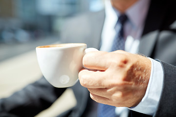 Image showing senior businessman hand with coffee cup outdoors